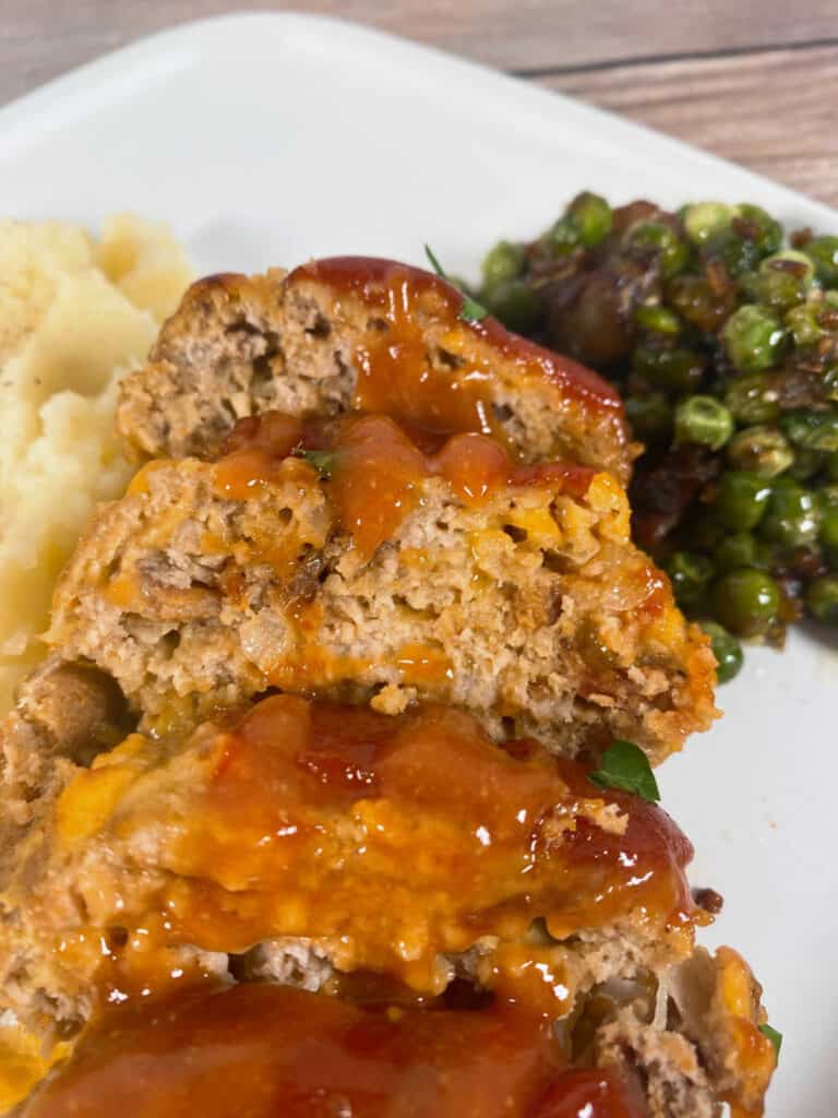 Mini meatloaf is sliced with glaze drizzled on top. 