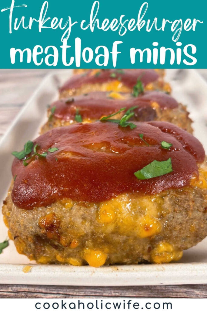 Image for Pinterest with recipe title text overlay at top. Close up image of a baked mini meatloaf, showing the melted cheese and baked on glaze. 