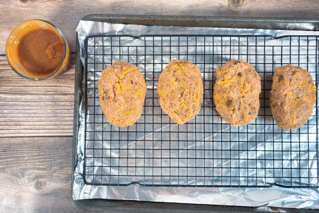 Process shot - meatloaves are formed and on the baking sheet, waiting to be glazed. 