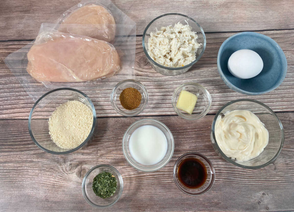 Ingredients for the recipe sit in glass bowls on a wooden background. 