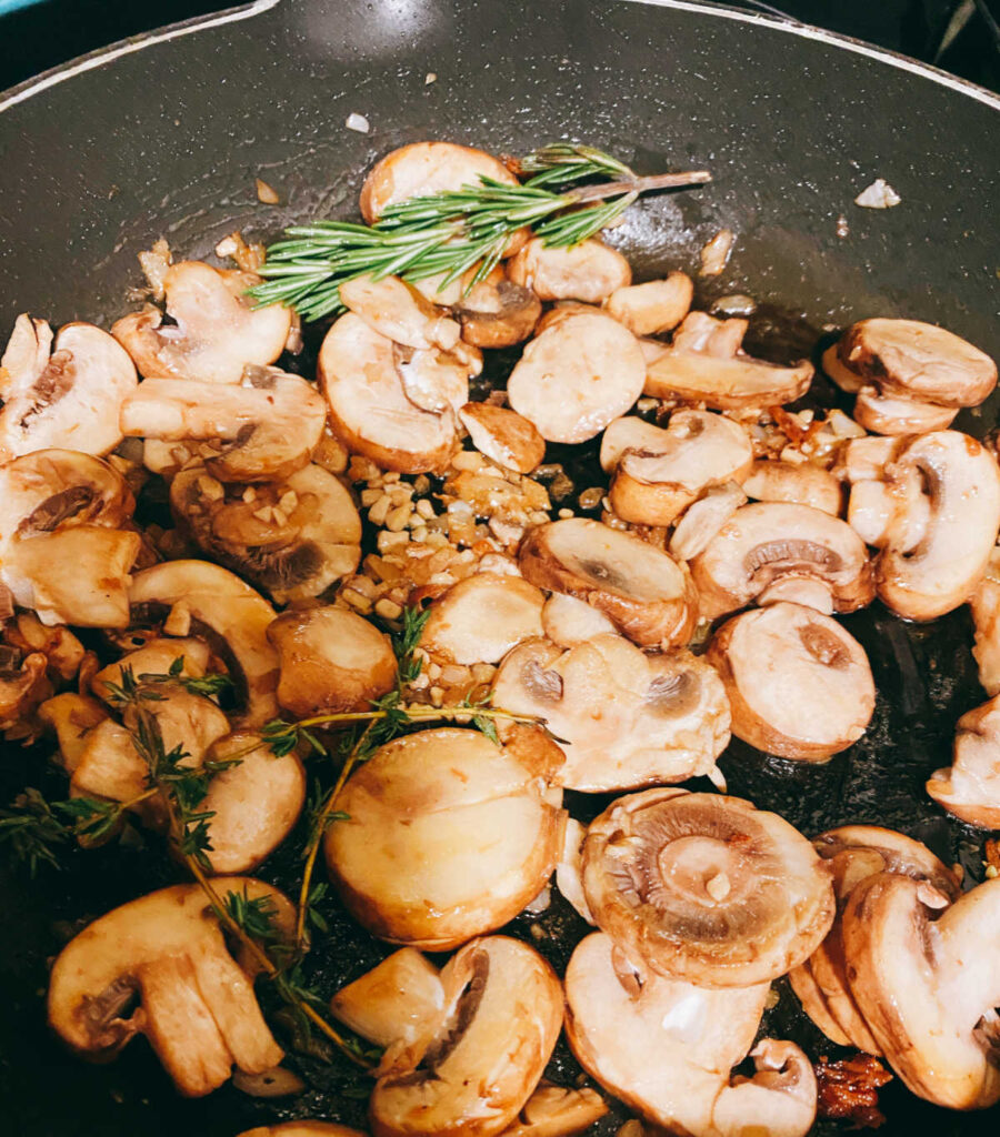 Process shot - mushrooms sauce cooking in a skillet. 