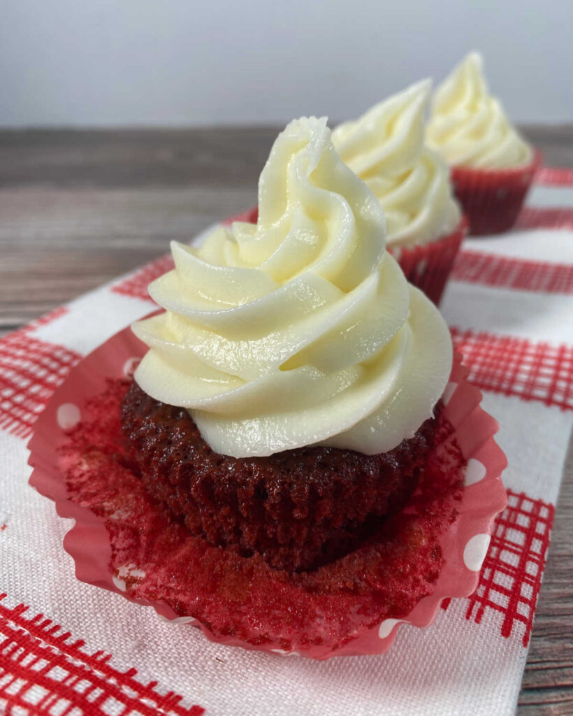 Cupcake with a wrapper pulled down to show the red coloring.