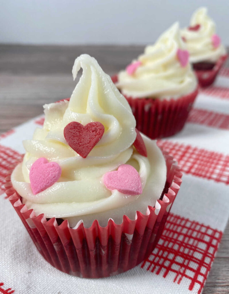 decorated cupcakes on a red checkered napkin.