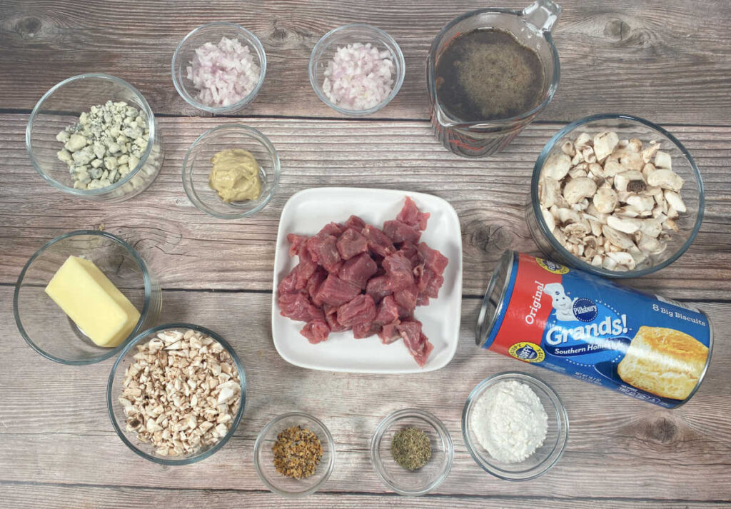 ingredients in glass bowls and plates on a wooden background. 