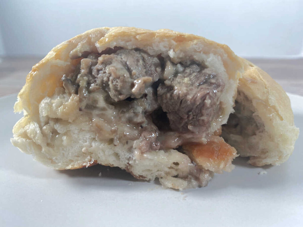 biscuit cut in half to show the inside before mushroom sauce is added. 