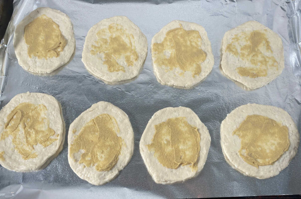 process shot - flatten biscuits brushed with Dijon mustard. 