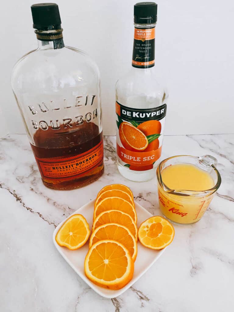 ingredients for the recipe sit on a marble background. 