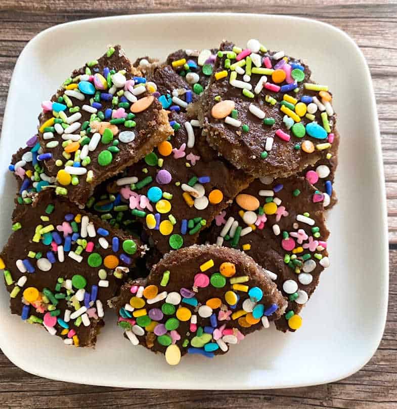 Pieces of Easter candy crack sit on a white plate.