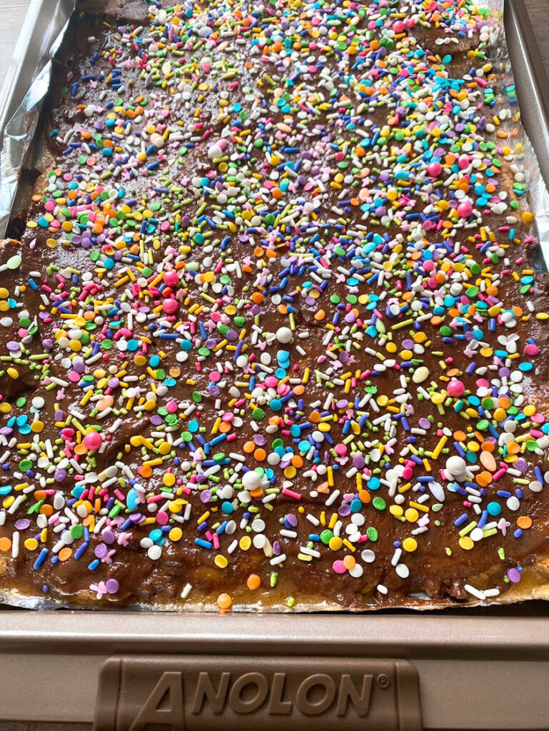 Process shot - Easter colored sprinkles on top of chocolate, waiting for the recipe to harden. 