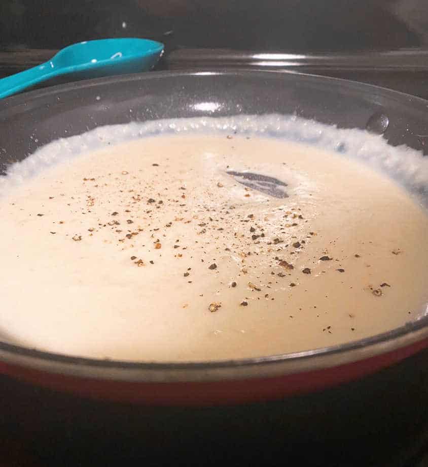 Process shot - close up image of cheese sauce in the skillet. 