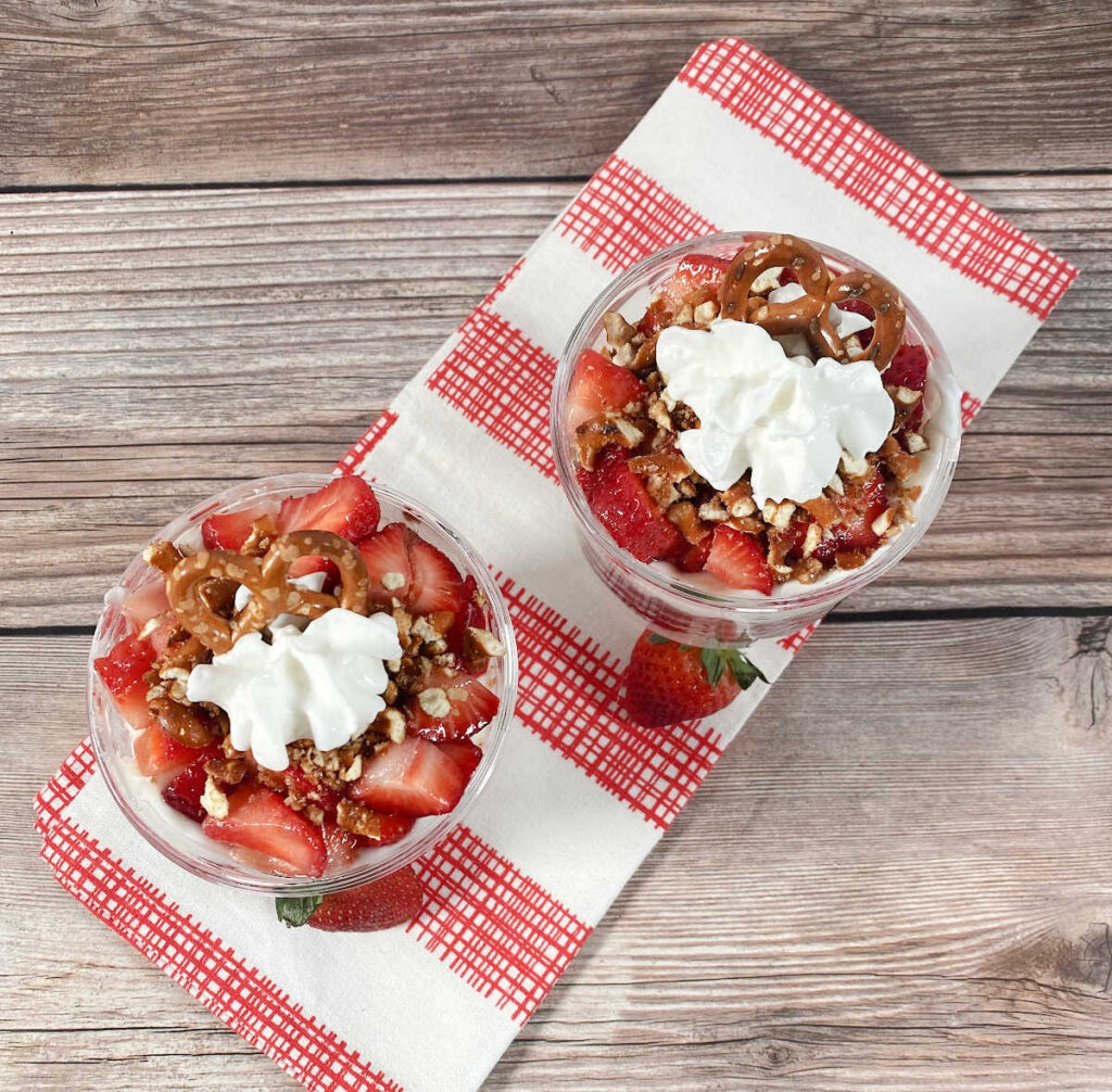 Overhead image of parfaits on a red and white plaid dish cloth. 