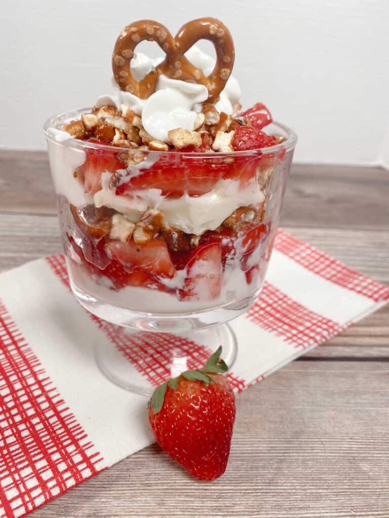 Close up image of parfait, showing the layers, topped with a mini pretzel twist. 