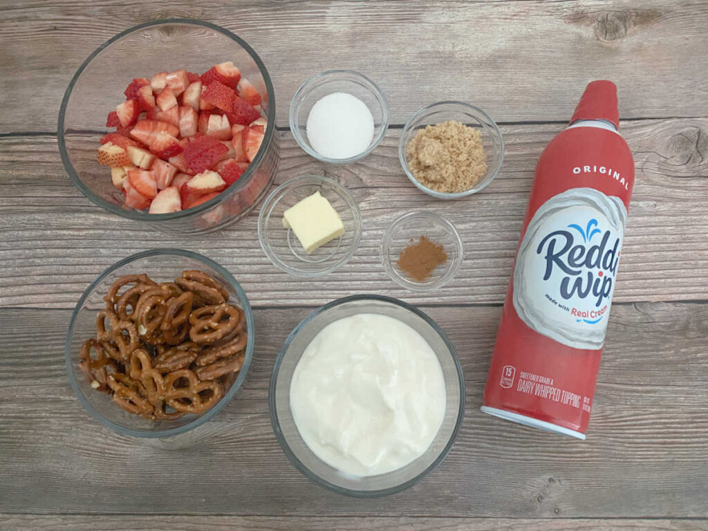 Ingredients for this recipe, portioned out in glass bowls, sitting on a wooden background. 