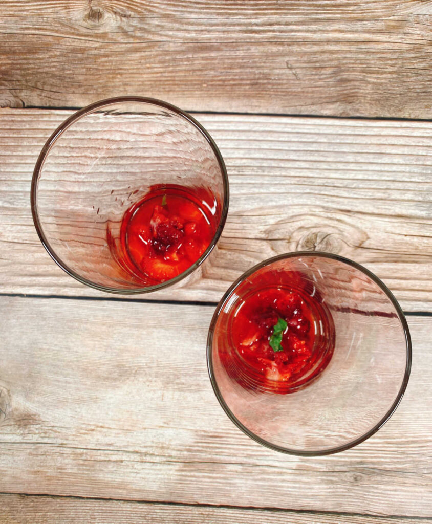 prep image - strawberry and basil mixture in a cocktail glass. 