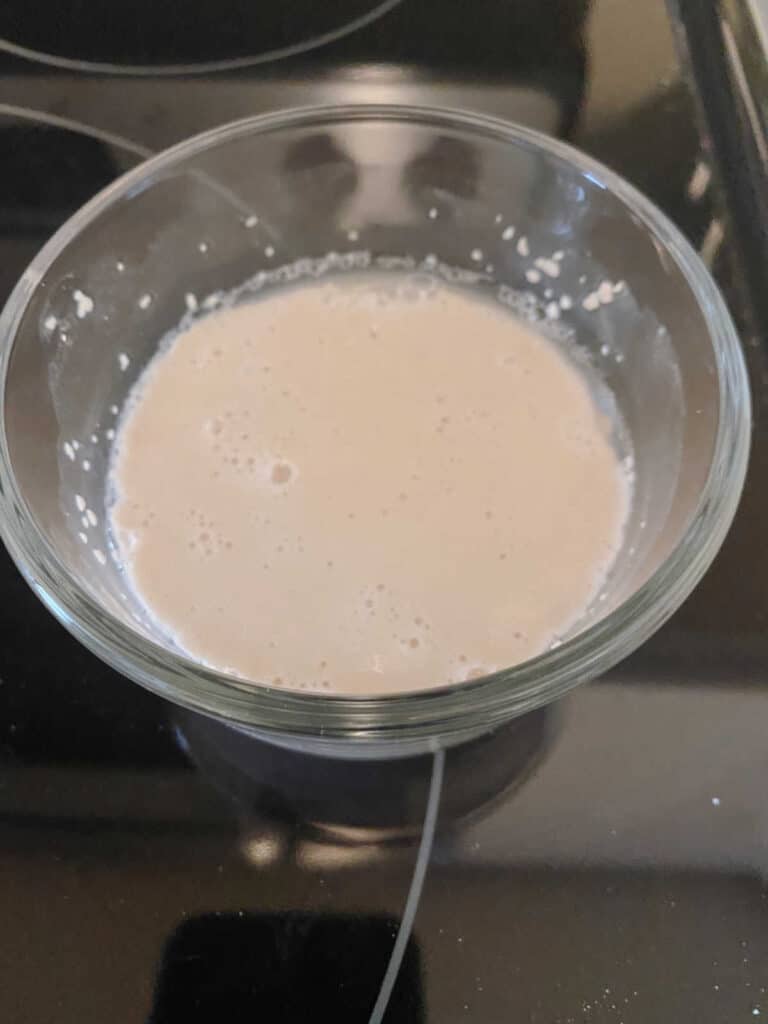 Process shot - yeast proofing in a small glass bowl. 