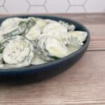 side image of salad in a dark blue bowl.