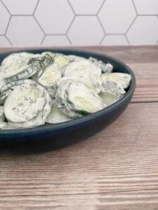 side image of salad in a dark blue bowl.