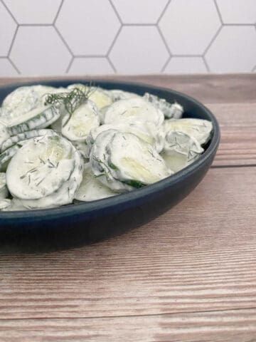 side image of salad in a dark blue bowl.