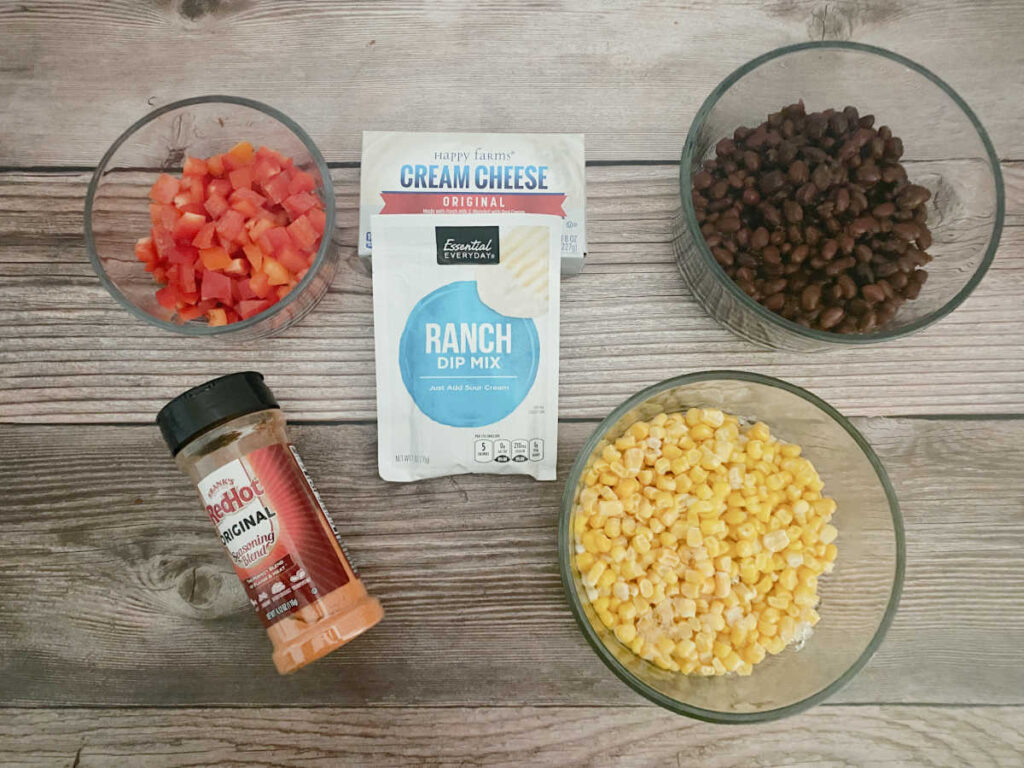 Ingredients for recipe sit in glass bowls on a wooden background.