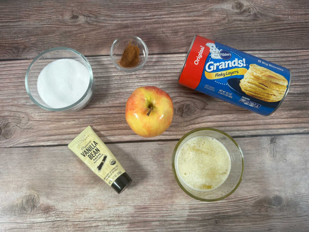 Ingredients for the recipe are in glass bowls on a wooden background. 