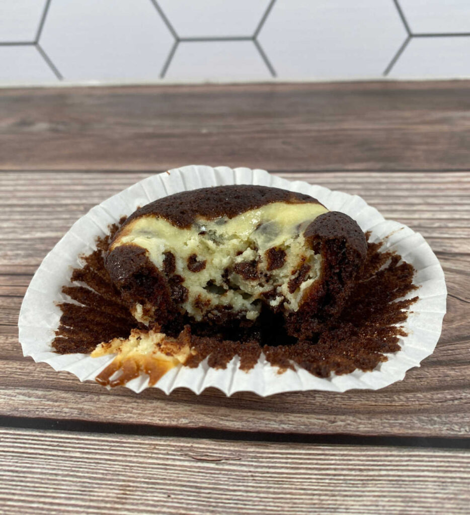 Close up image of half a cupcake on a wrapper. 