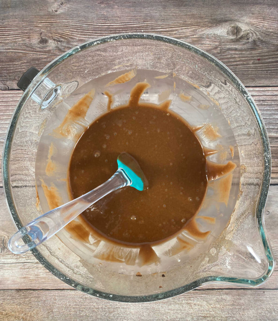 Process shot - overhead image of cupcake batter in a glass bowl. 