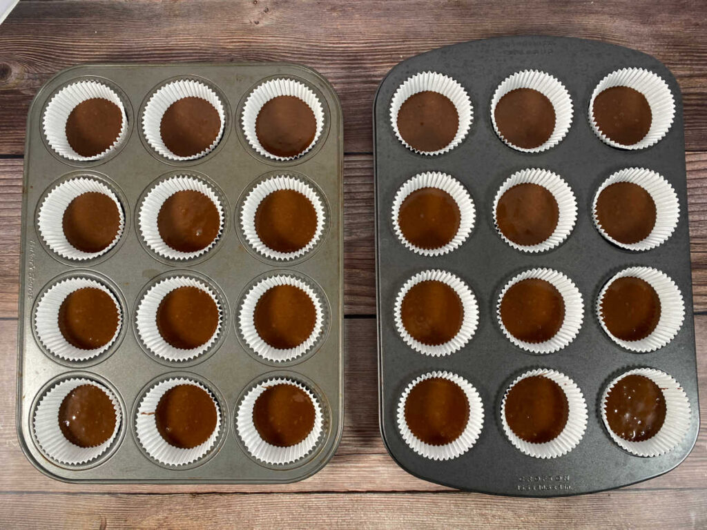 Process shot - cupcake batter poured into cupcake liners. 