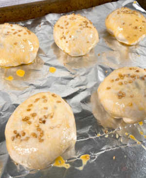 Process Shot - burger bombs brushed with egg wash and topped with sesame seeds. 