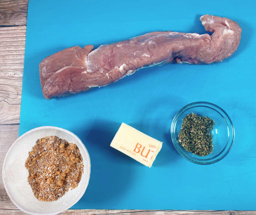 Ingredients for the recipe sit on a blue cutting board. 