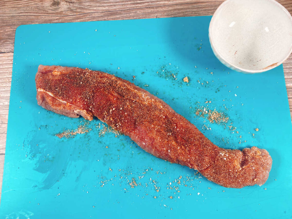 Process shot - spice rub ingredients on pork. 