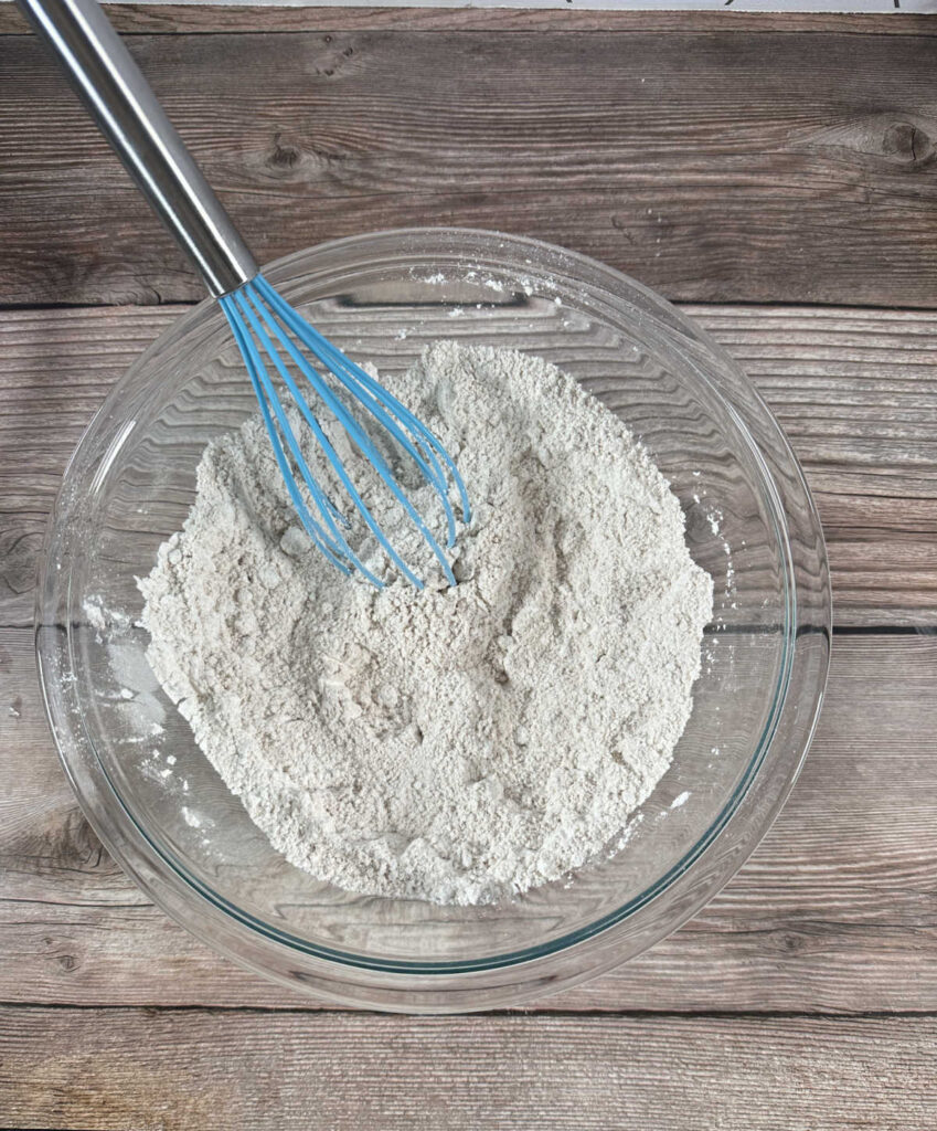 Process shot - dry ingredients whisked together in a glass bowl. 