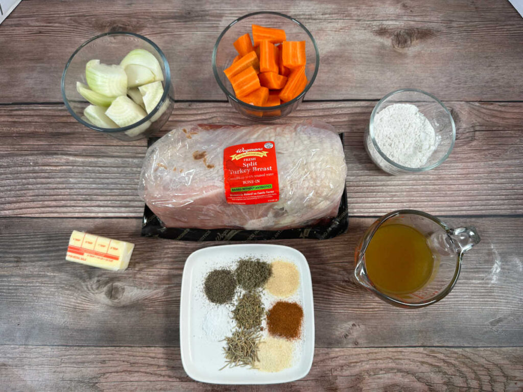 Ingredients sit in glass bowls and white plates on a wooden background. 