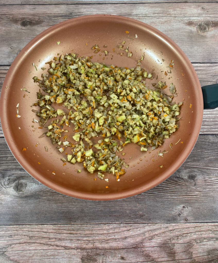 Process shot - vegetables and seasonings in a copper skillet. 