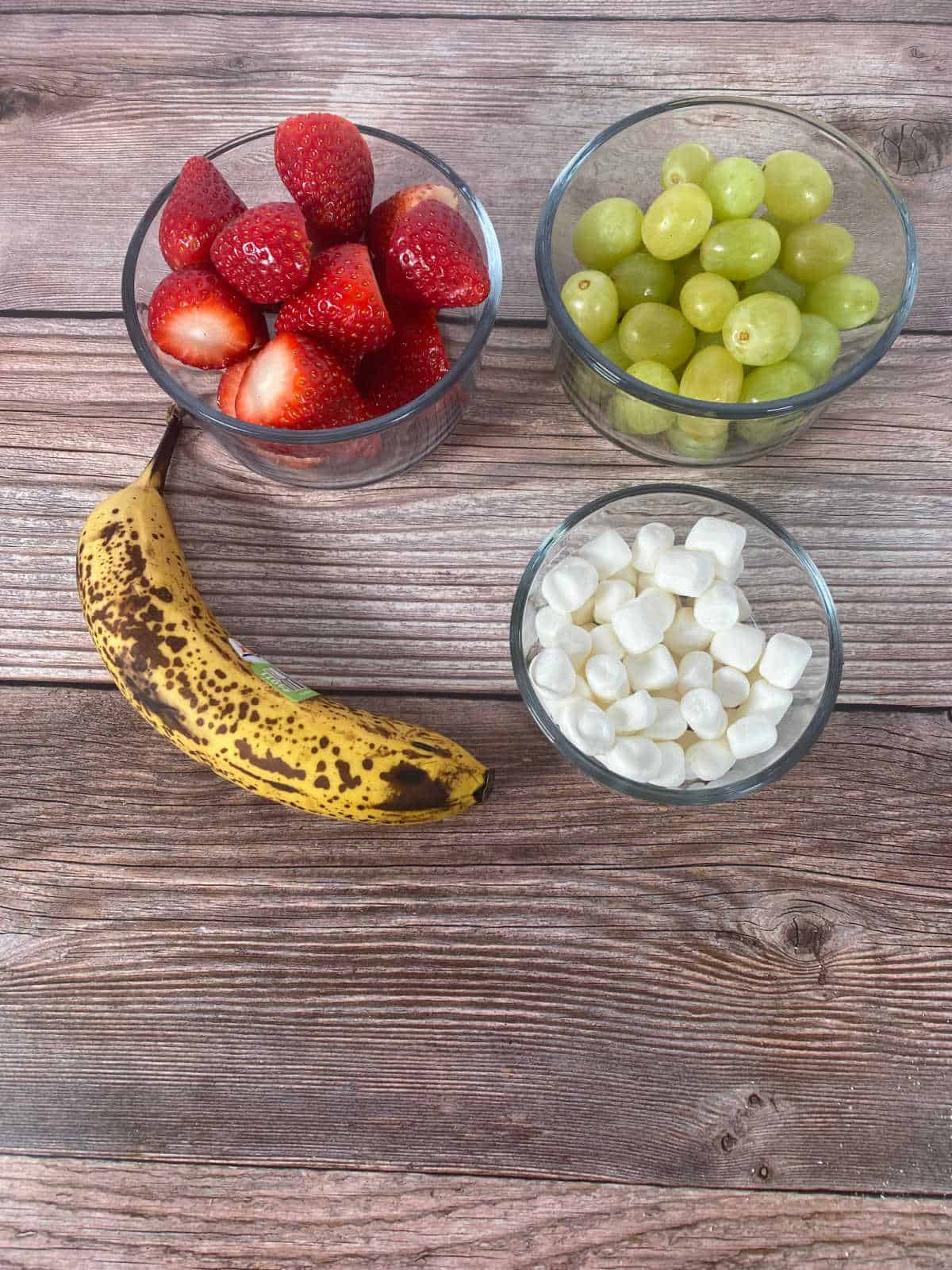 Ingredients in white bowls on a wooden background. 