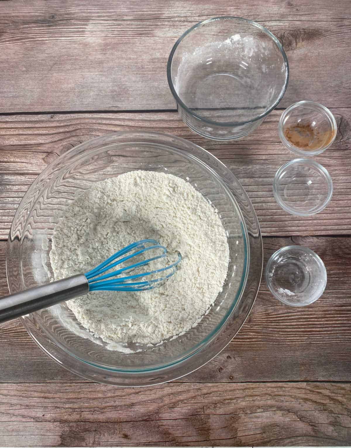 Process shot - Dry ingredients whisked together in a glass bowl. 