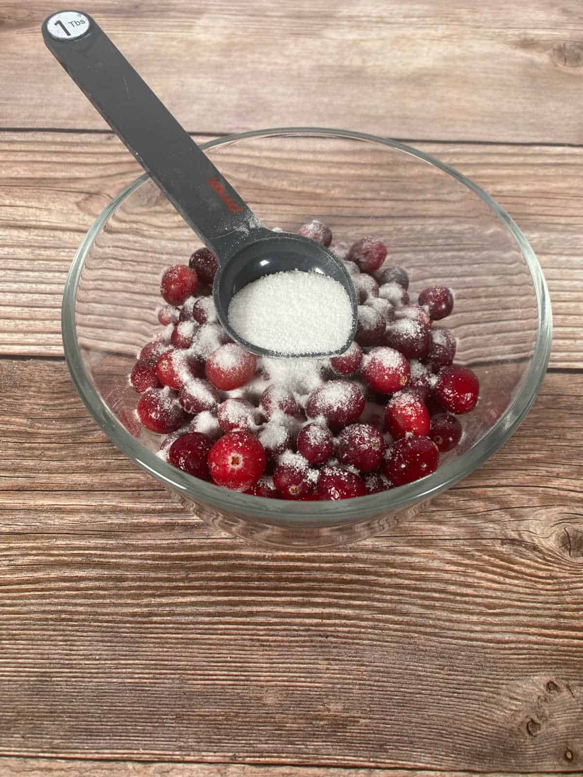 Process shot - cranberries being coated in sugar. 