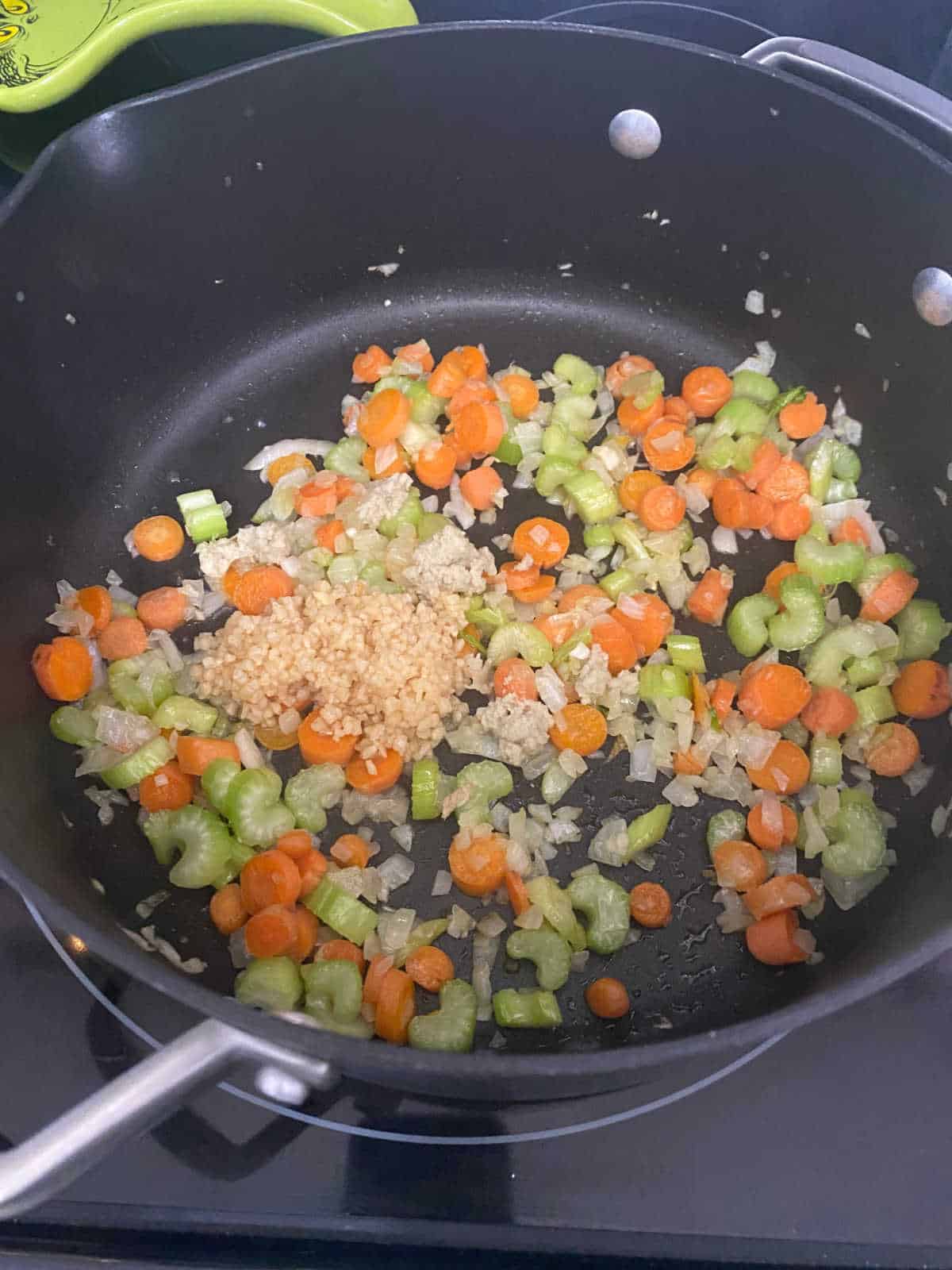 Process shot - vegetables in stock pot with garlic and ginger. 