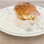 Side view of slider on a white, floral plate.