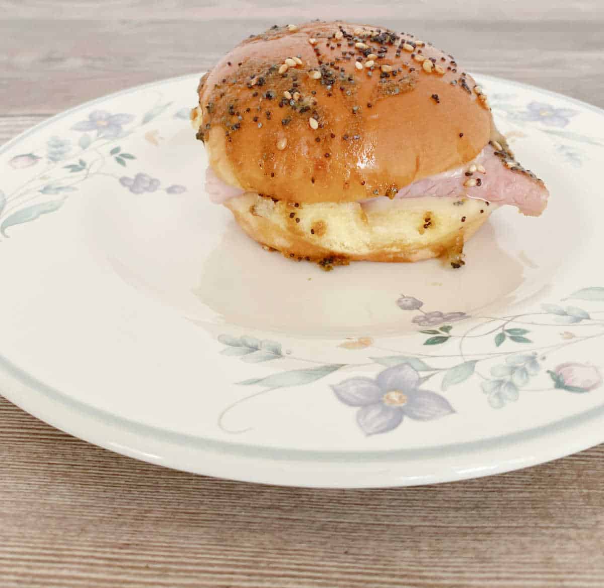 Side view of slider on a white, floral plate.