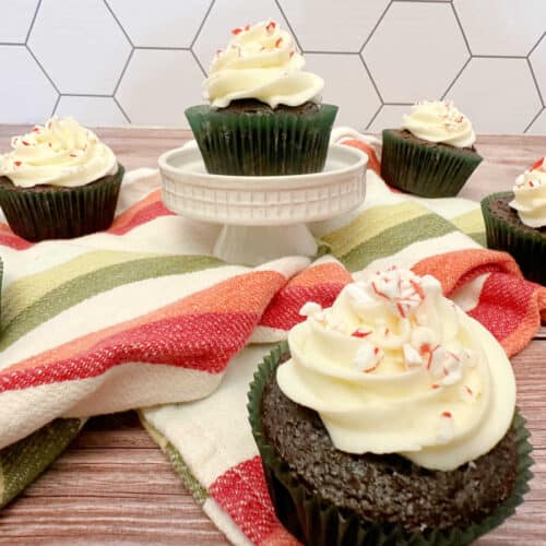 Cupcakes on wooden background with striped napkin