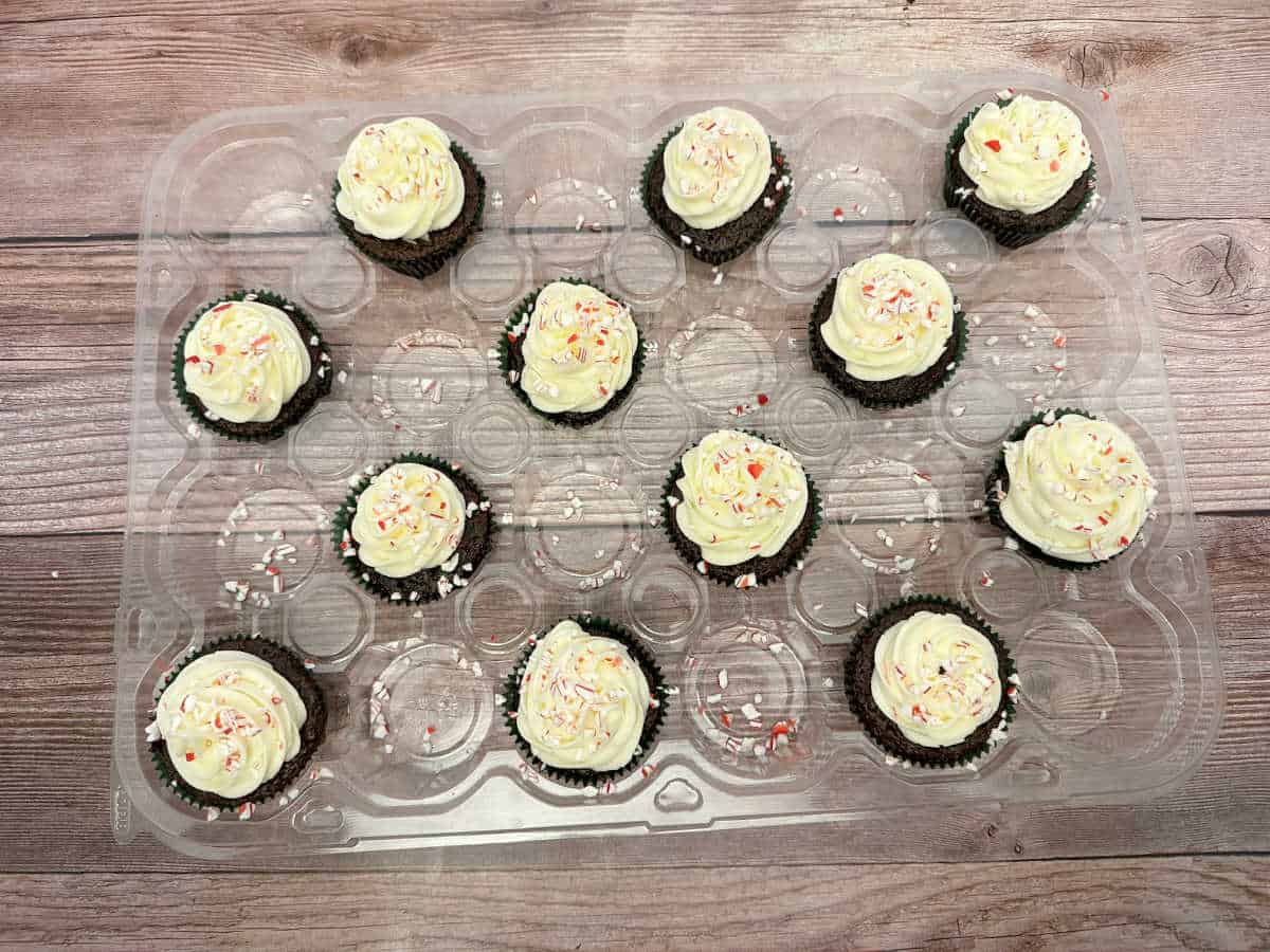 Frosted and decorated cupcakes in a carrying tray. 