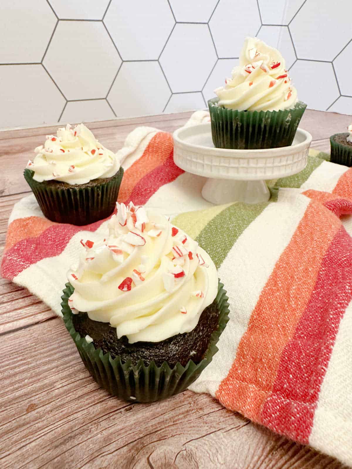 Cupcakes on a white, red and green striped napkin.