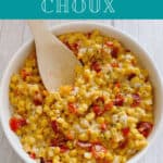 Image for Pinterest with text overlay. Overhead image of recipe in a round, white bowl with a wooden spoon scooping the corn mixture out.