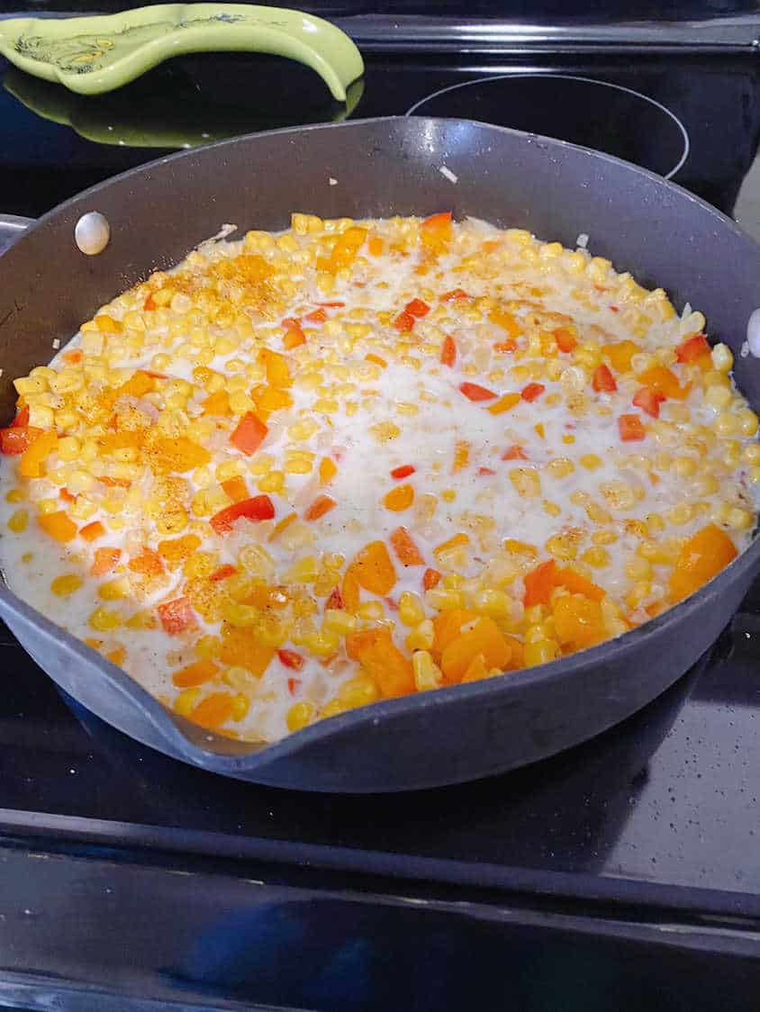 Process shot - milk added to the skillet with the corn and vegetables. 