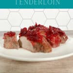 Image for Pinterest with text overlay. Sliced pork topped with crabberry sauce sits on a round white plate.