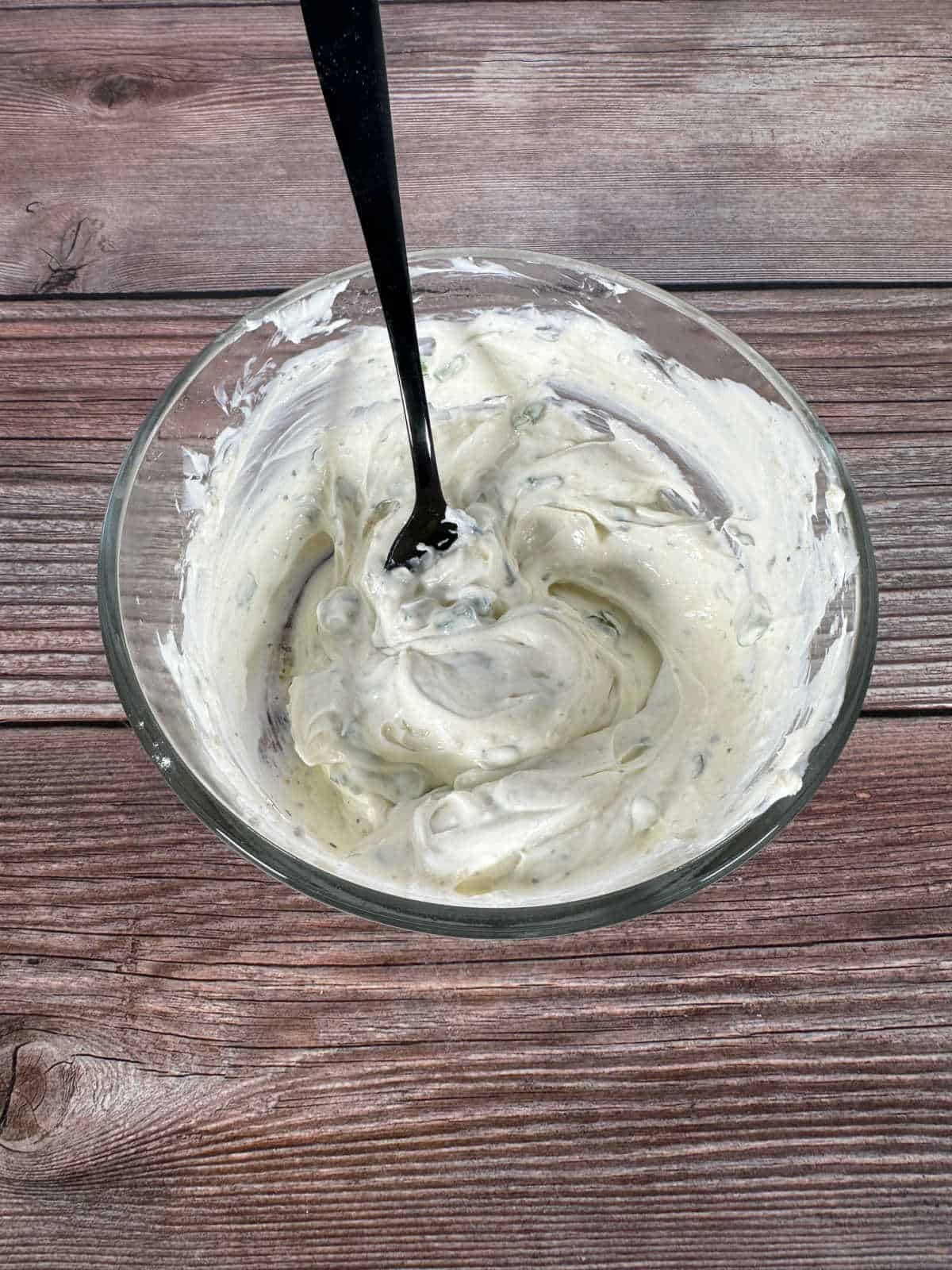 Process shot - cream cheese and ranch seasoning mixed together in a glass bowl. 