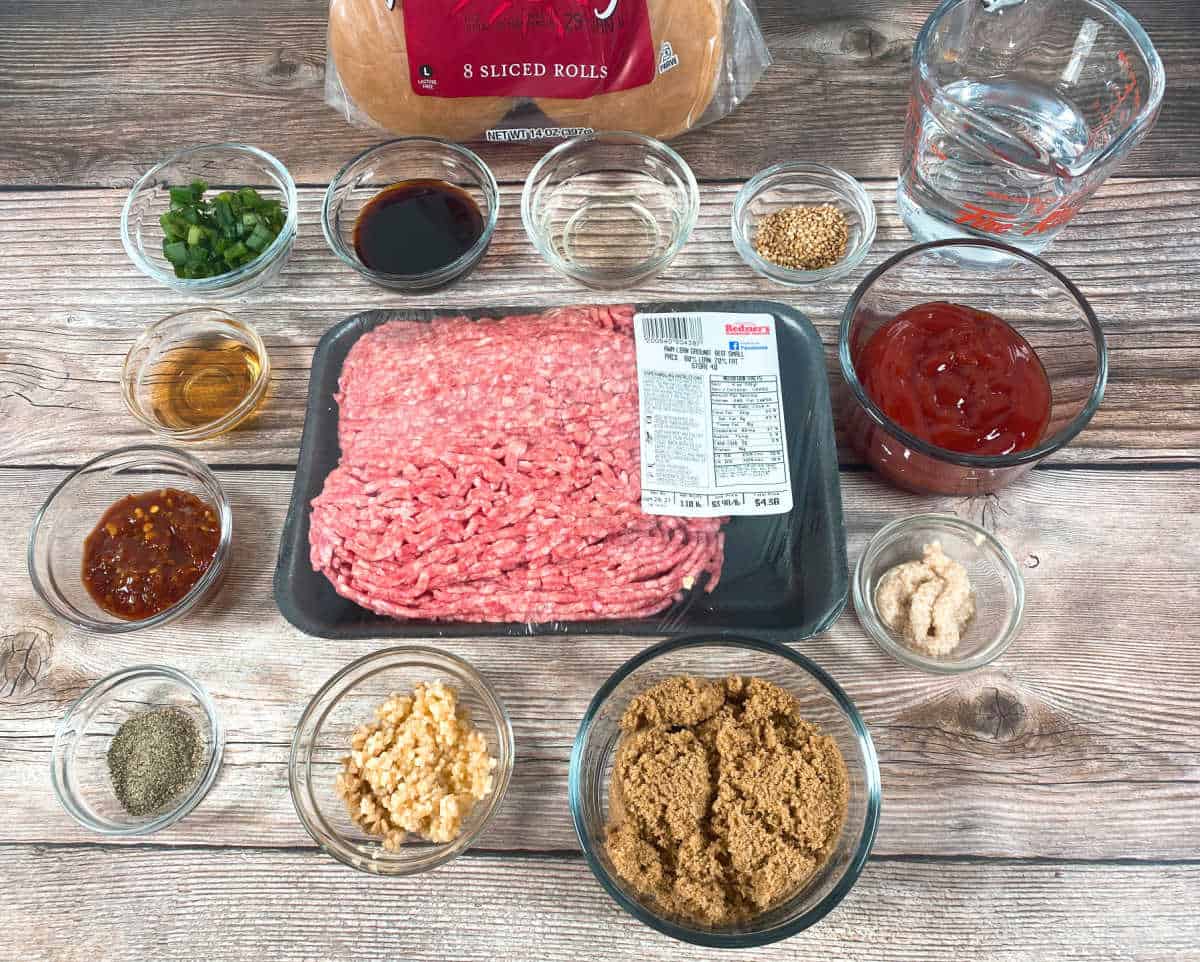 Ingredients for the recipe sit in glass bowls and dishes on a wooden background. 