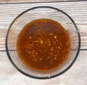 Process shot - ingredients for the sauce mixed in a glass bowl. 