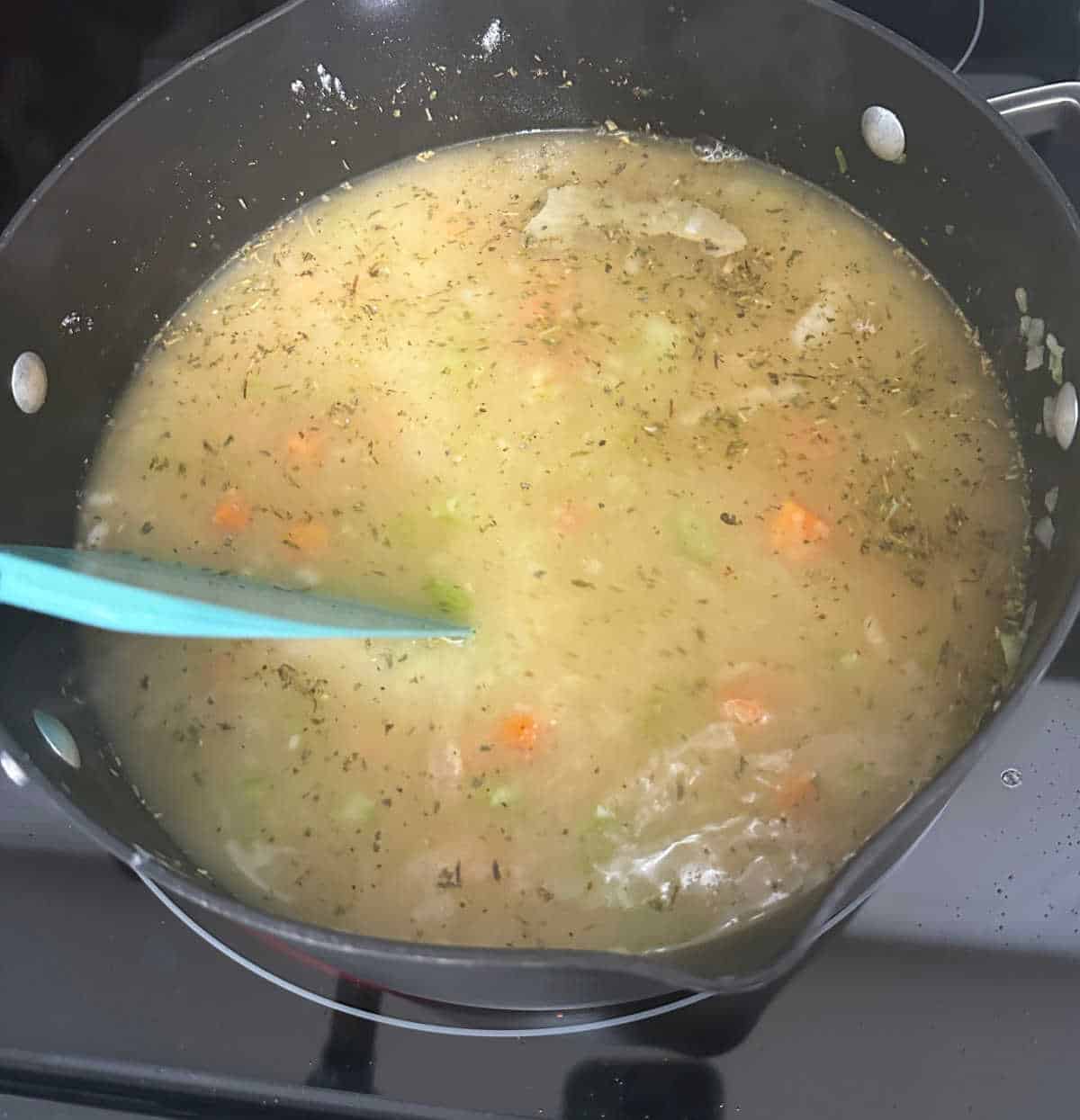 Process shot - additional soup ingredients added to the pot. 