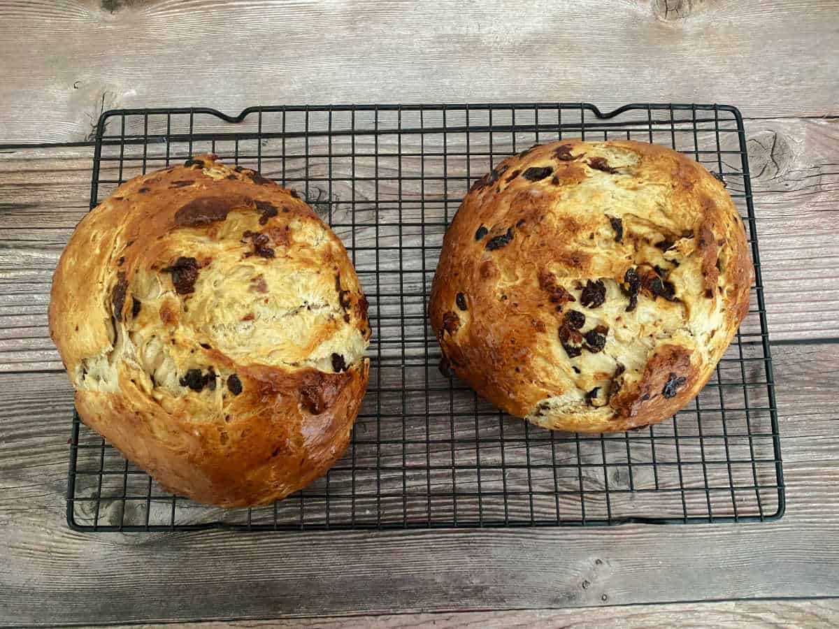 Process shot - two loaves of baked easter bread cooling on wire rack. 